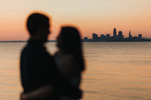 blurry couple embracing and view of a distant city 