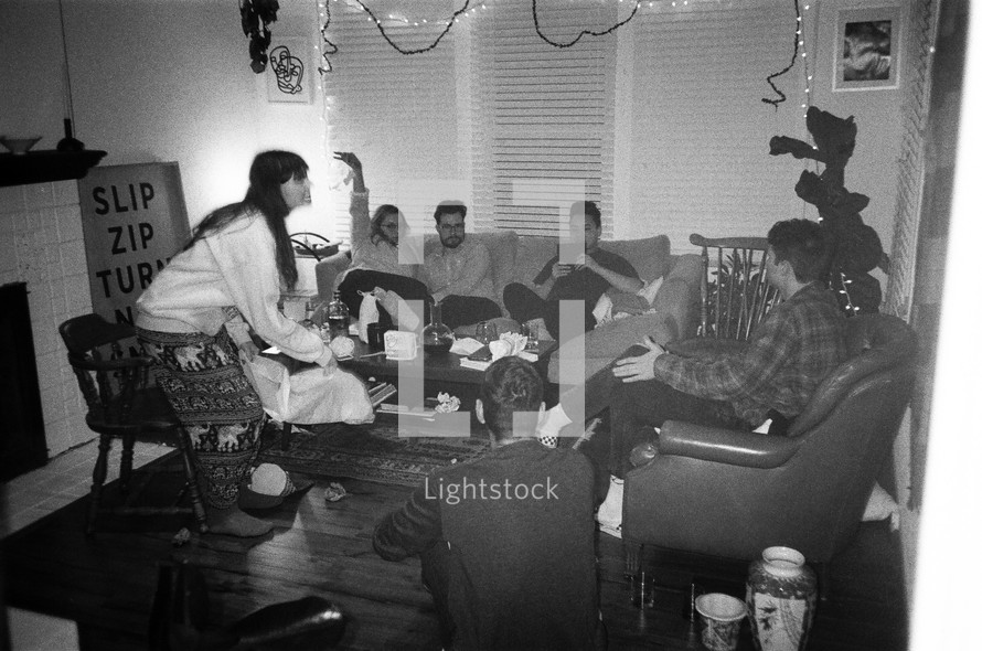 friends sitting on couches in a living room talking 