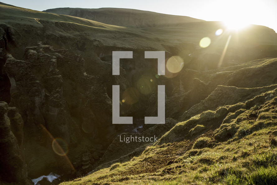 sunbeams shining on a green landscape in Iceland 