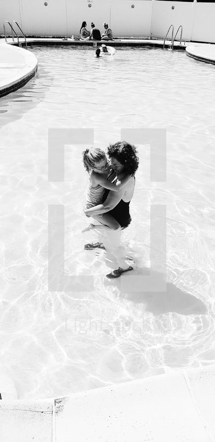 mother and daughter in a swimming pool 