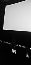 man in a dark auditorium 