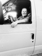 man driving a work van 