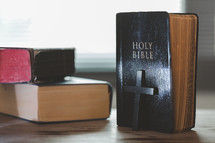 Stacked Bibles with cross