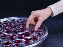 Communion glass cups on tray filled with wine,  the symbol of Jesus Christ blood 