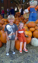 happy children in a pumpkin patch in October 