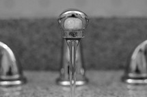 water pouring out a faucet 