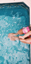 dangling feet in a pool 
