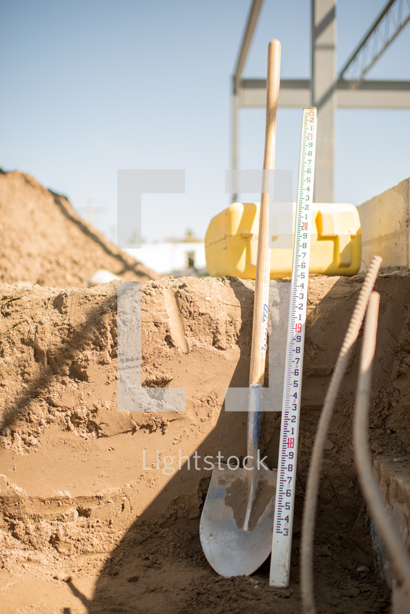 shovel and yardstick at a construction site 
