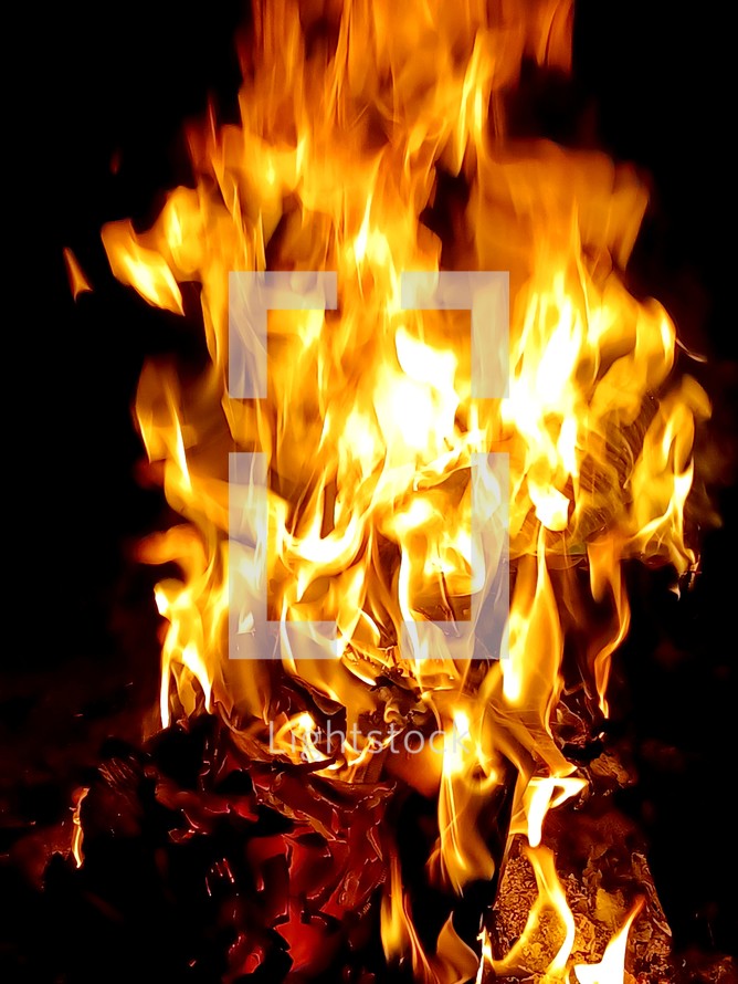 Fiery Flames shooting up from a fiery background showing yellow and orange flames against a black background. 