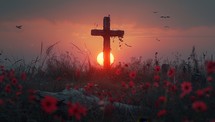 An old wooden cross stands in a field of red flowers at sunset. The sky is dark and there are birds flying in the background.