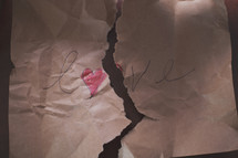 a crumpled and ripped page symbolizing broken heart