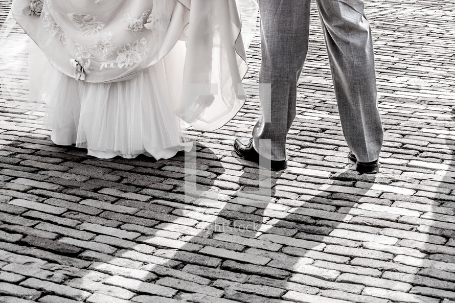 bride and groom dancing on brick pavers 
