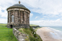stone round building along an Irish coast 