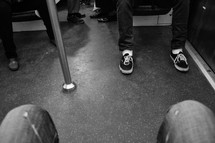 passengers feet on a subway train 