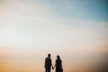 silhouette of a couple holding hands 