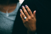 woman's hand with an engagement ring 
