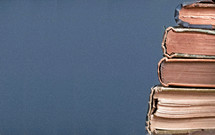 Stack of old books on a blue background