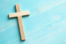 wood cross on a blue wood background 
