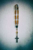 rosary hanging on a wall 