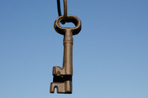 Old ring of keys hang against blue sky.