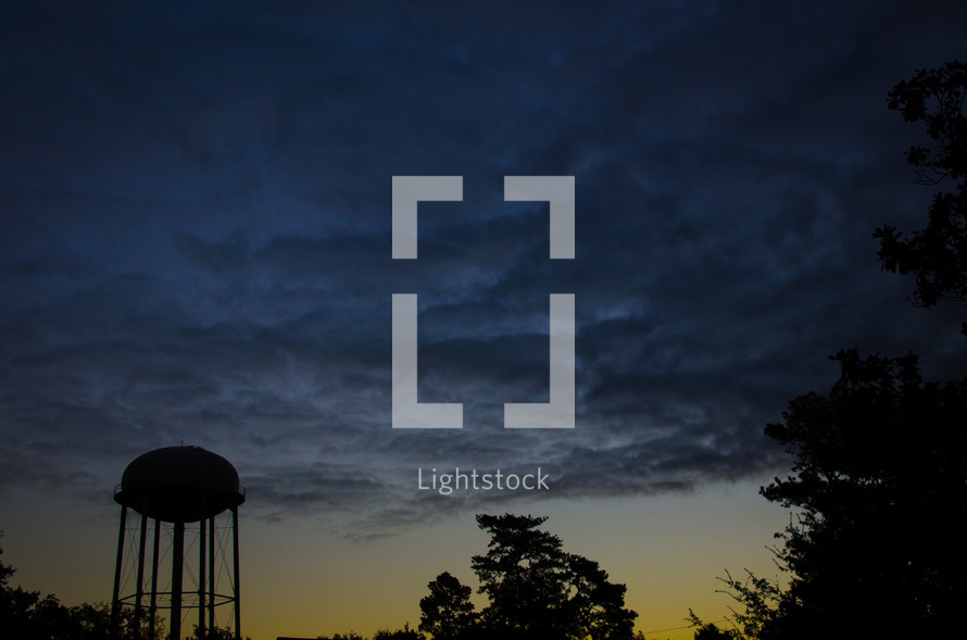 silhouette of a water tower at dusk 