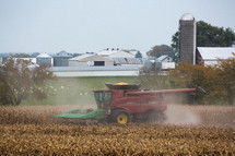 tractor harvesting wheat in a field 