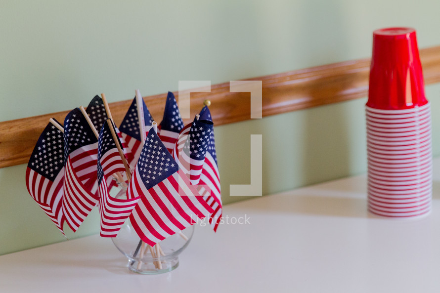 American flags in a vase and red solo cups 