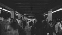 People walking through Brooklyn subway tunnel.