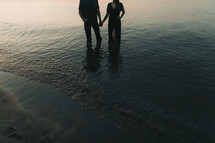 a couple standing in water 