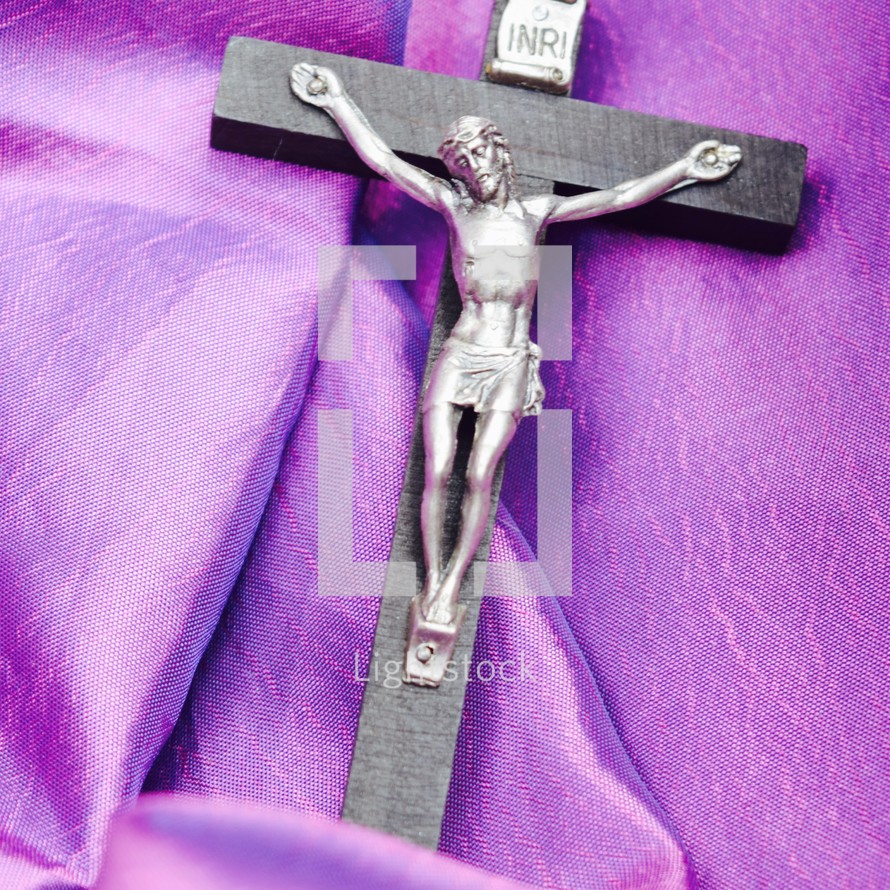 crucifix on purple fabric 