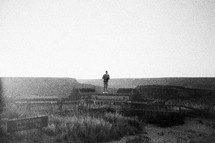 a man standing at a viewing area for the Grand Canyon 