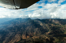 wing of a plane flying over mountains in Kenya 