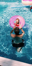 father and infant swimming 