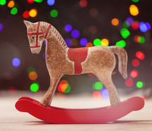 rocking horse ornament and colored bokeh lights 