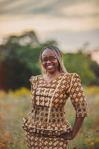 African-American woman in an ethnic dress standing outdoors 