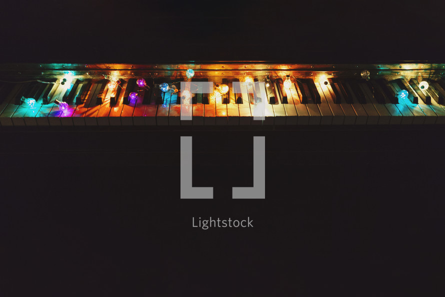 string lights on acoustic piano with copyspace