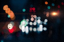drops on the window and street lights background at night