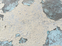 cracked, peeling paint on a concrete surface - beige, gray, light blue
