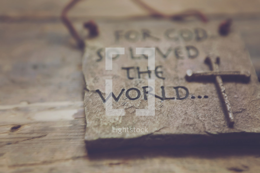A plaque reading, "For God so loved the world."