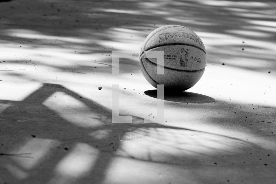 basketball and a shadow of a basketball net 