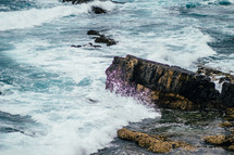 Ocean waves crashing upon a rocky shore.