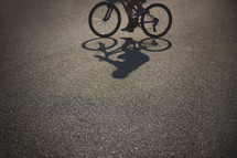 shadow of a child riding a bike