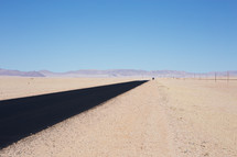 A black road through a barren landscape.