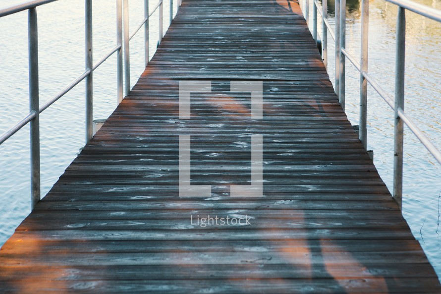 wood boards and metal railings on a pier. 