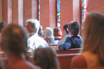 parishioners sitting in church pews at a Lutheran church 