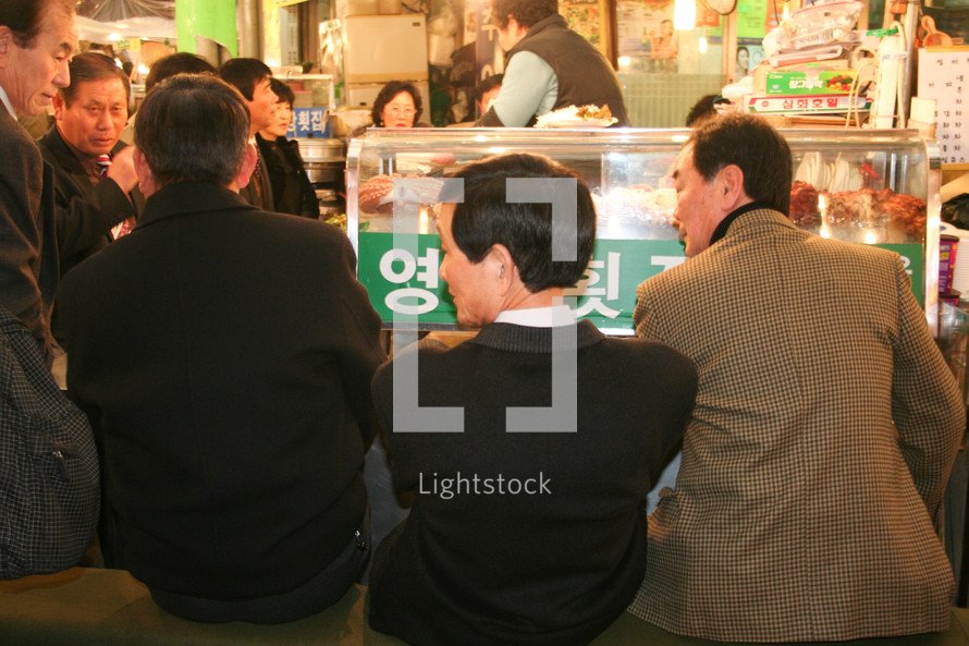 men eating at a Korean restaurant 