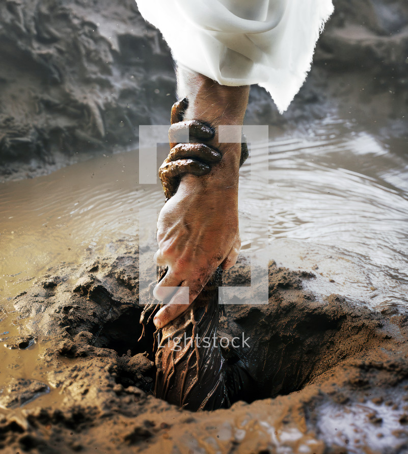 Jesus' hand reaching down and pulling someone out of the mud.
