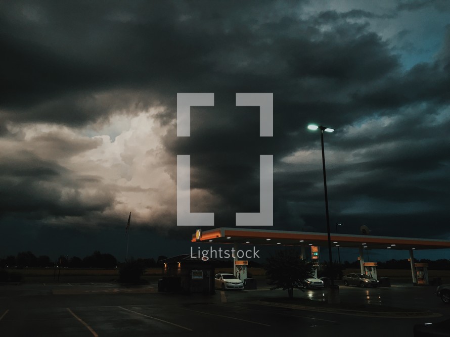 gray clouds over a gas station 