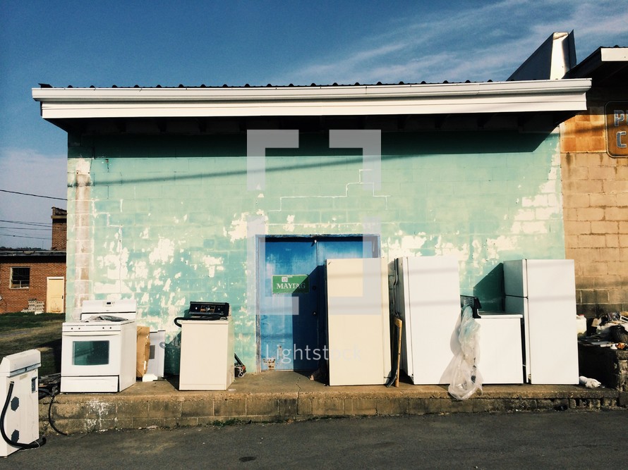 used appliances in front of an old building 