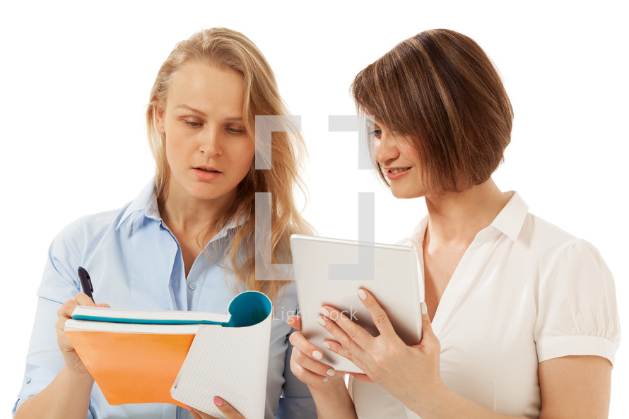 Woman showing something in her folder to colleague
